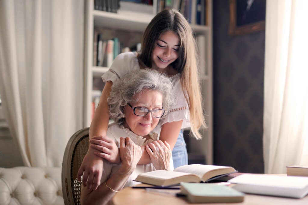 grandmother and granddaughter read together - photo for our aging parents blog post on Chicago North Shore Moms.