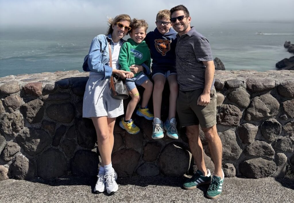Meet a Mom: Mastering College Admissions with Samantha Herscher, Founder of Gradfit. Samantha poses at a beach with her family.