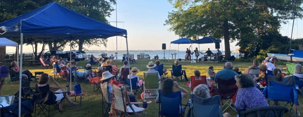 Relaxed outdoor concert at Ocean City with families and children enjoying music by the water.