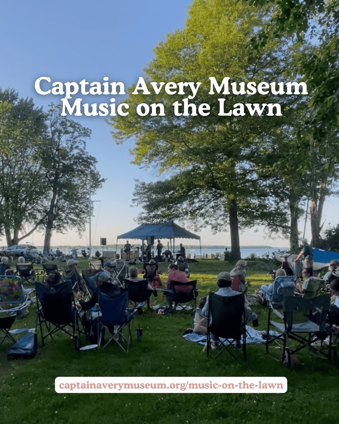 People enjoying outdoor music at Captain Avery Museum on the lawn with trees and water in background.