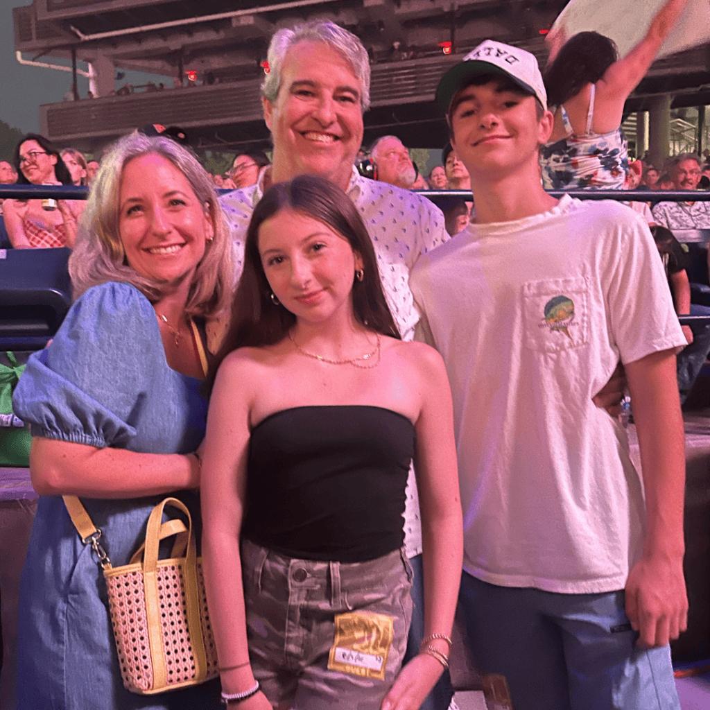 Family enjoying a concert at Ocean City with kids and adults smiling outdoors.