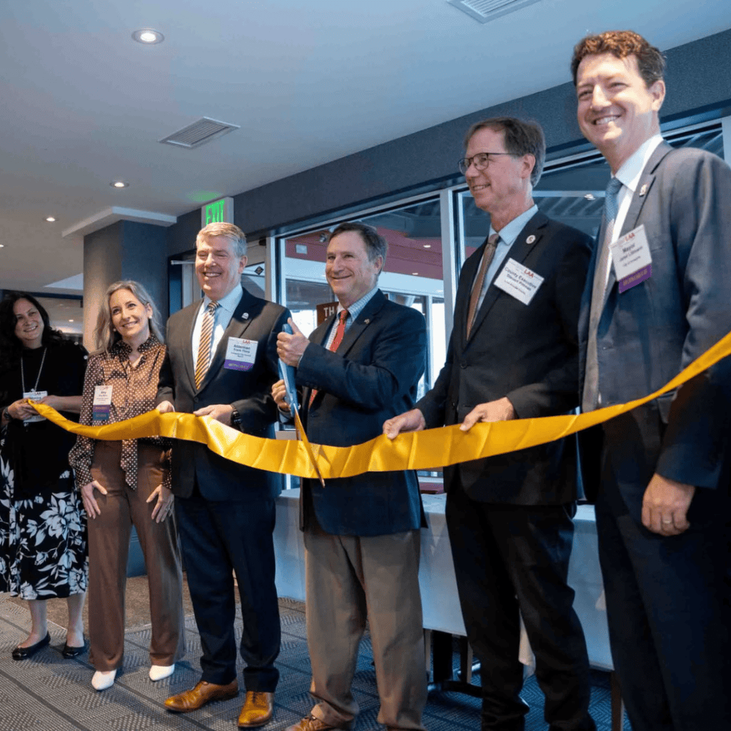 Ocean City Moms event with professionals cutting ribbon at a conference.
