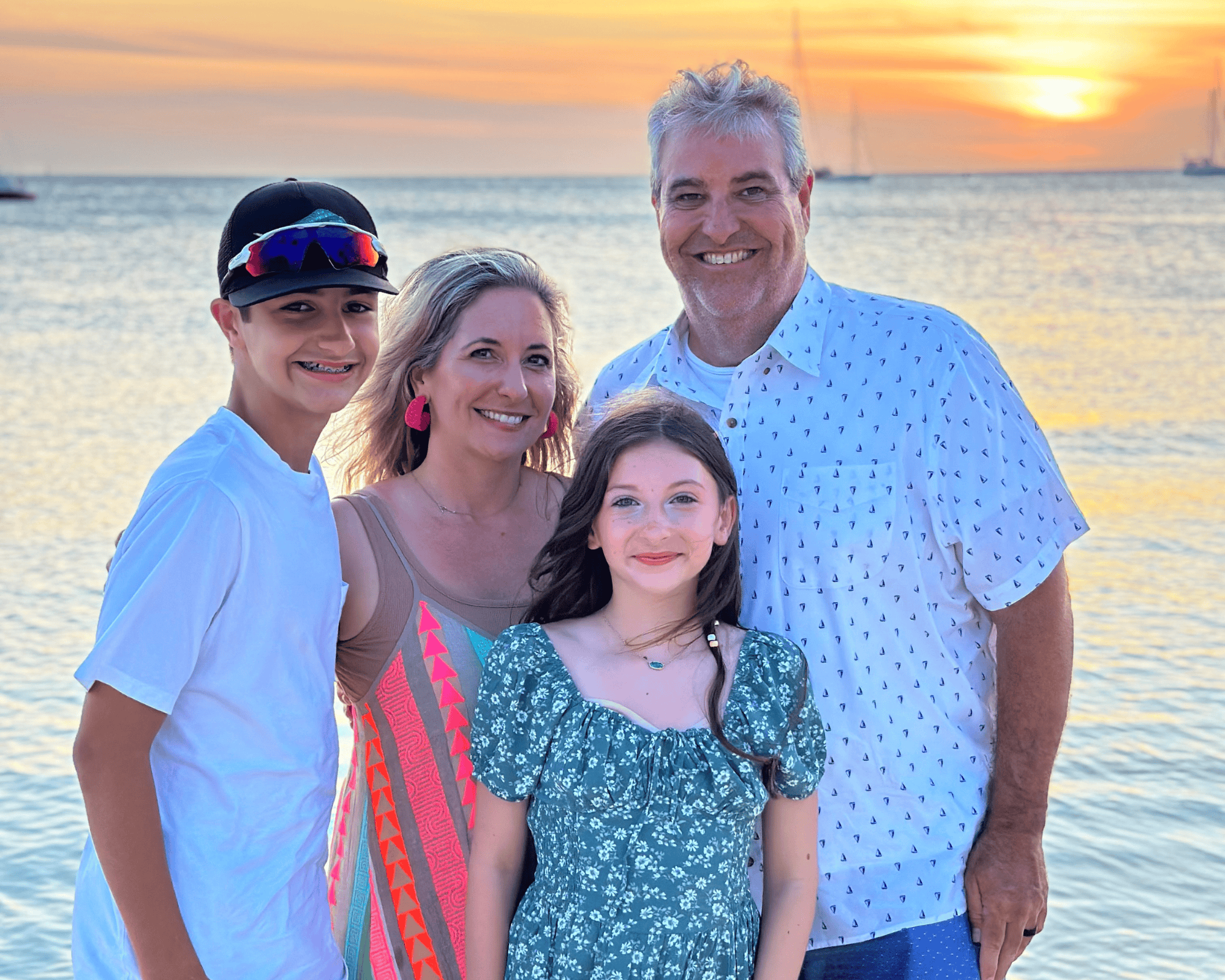 Family enjoying sunset at Ocean City beach with kids and parents smiling.