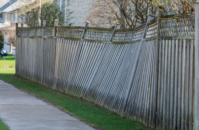 leaning fence that needs replacement