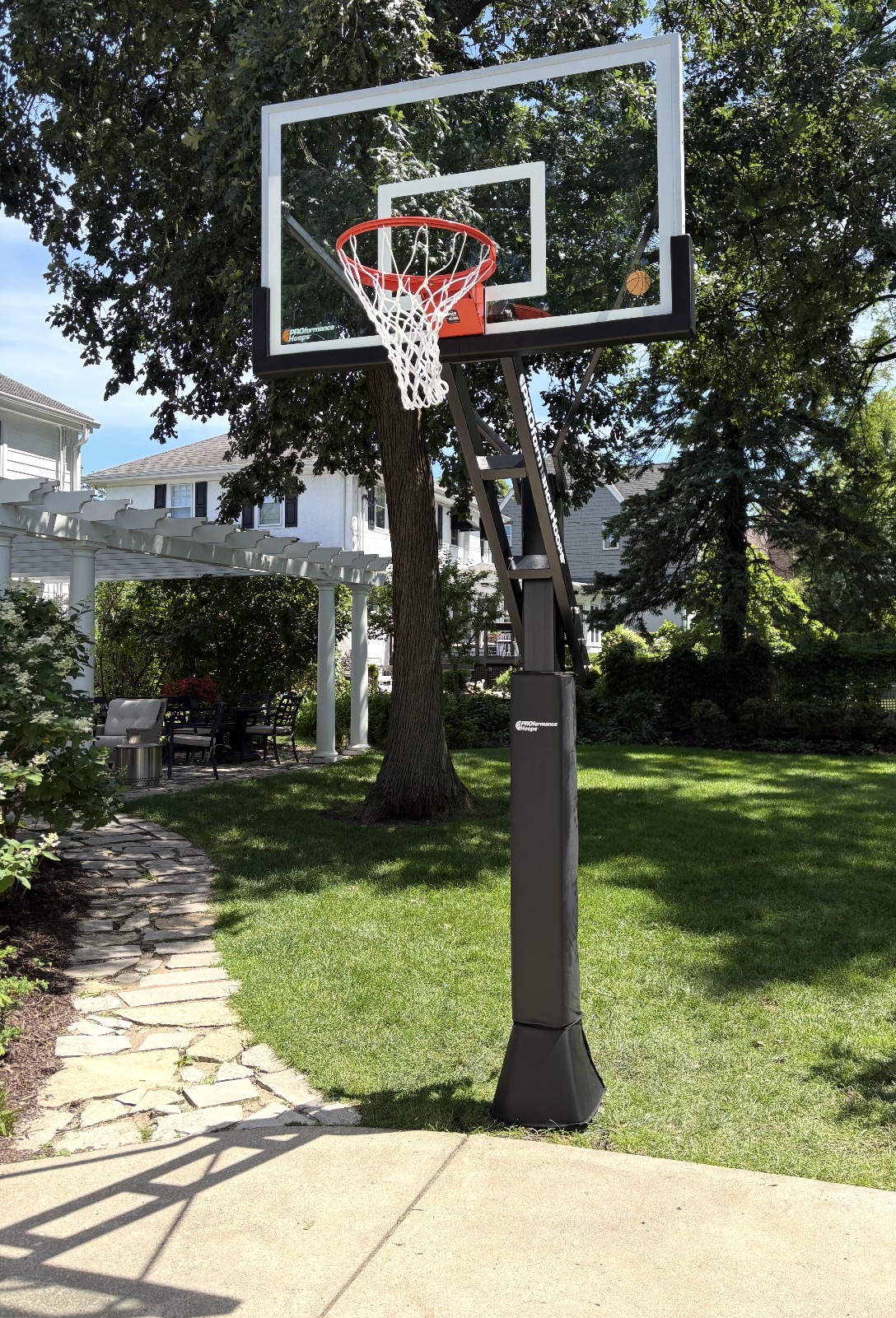 professional in-ground basketball hoop installed in a residential backyard