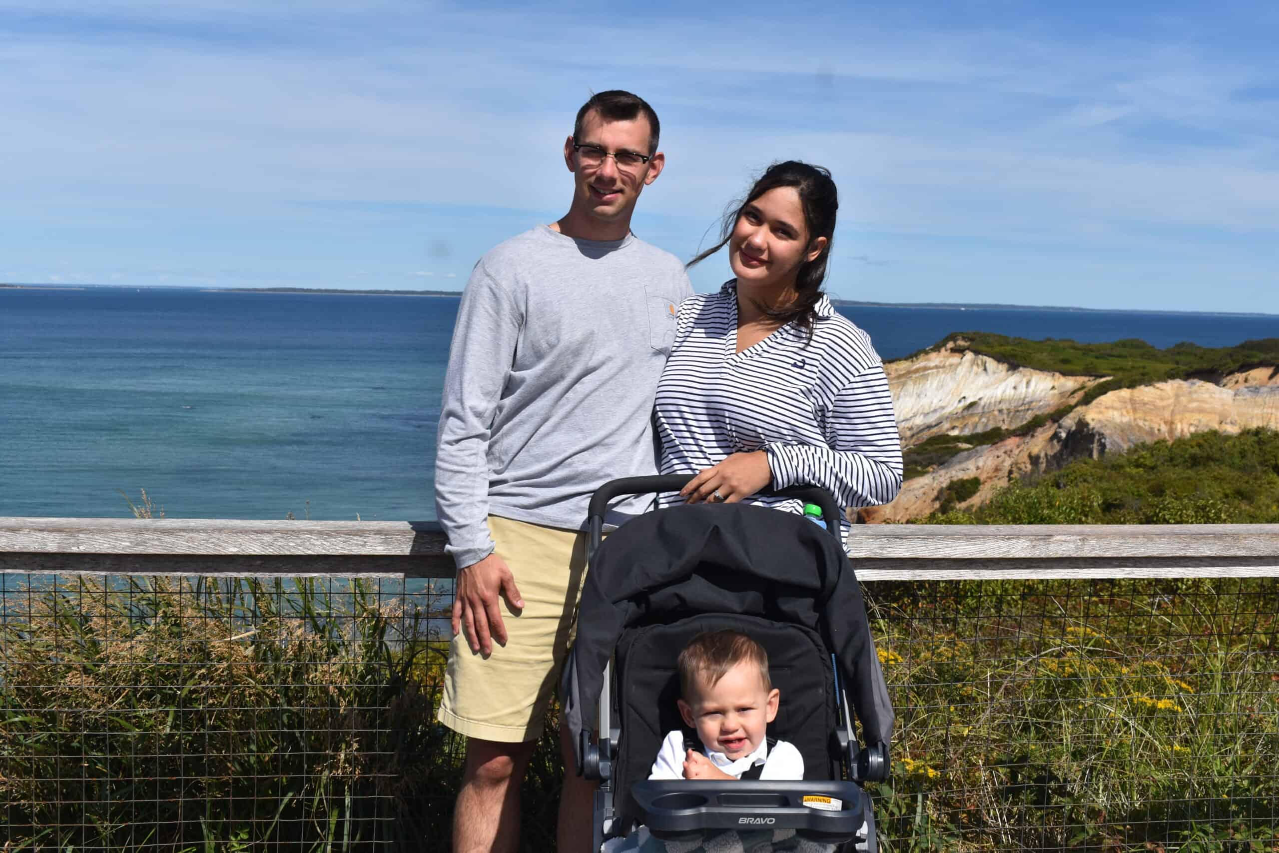 Family enjoying ocean view at Ocean City with stroller and scenic cliffs.