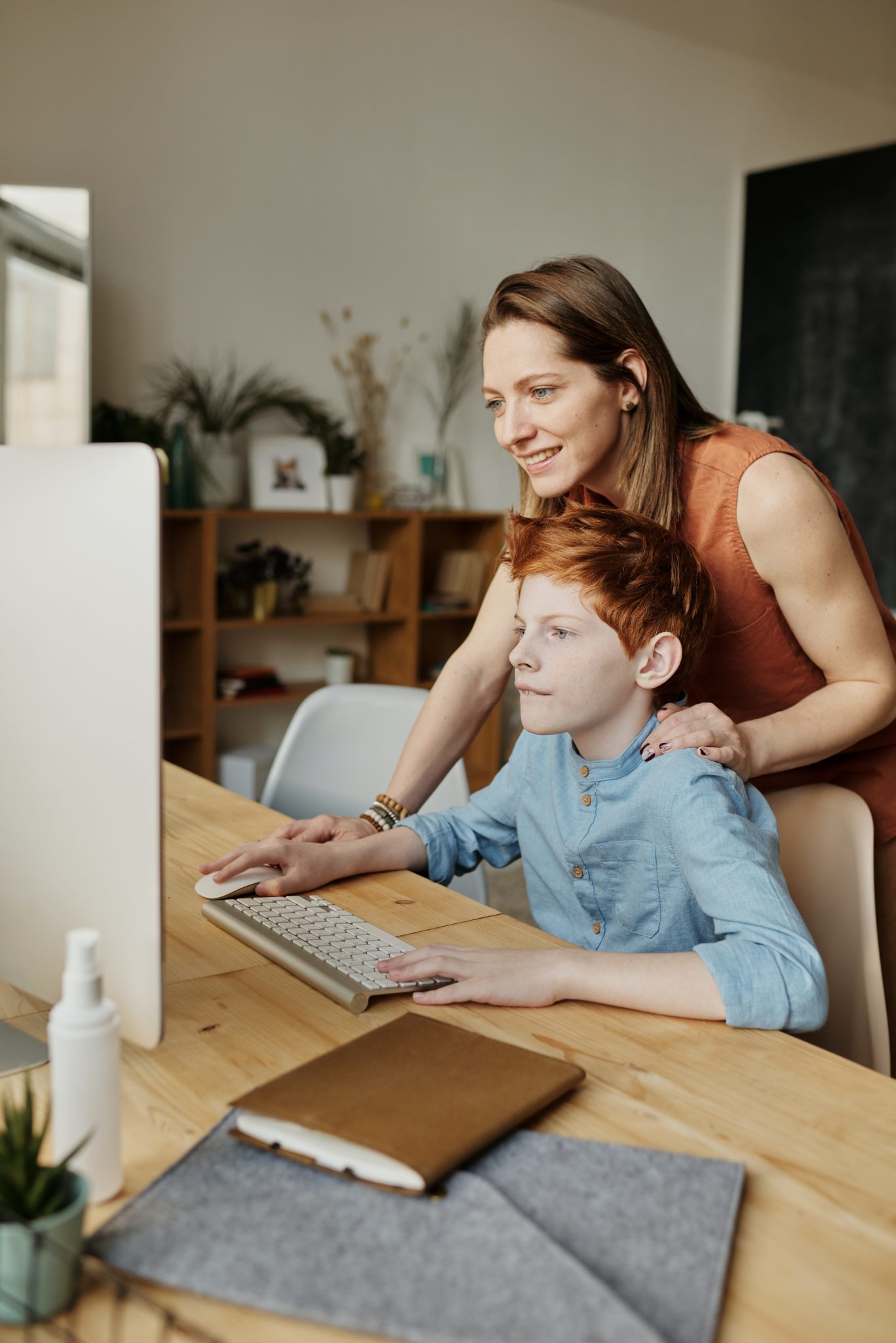 photo-of-woman-and-boy-looking-at-imac-4145347