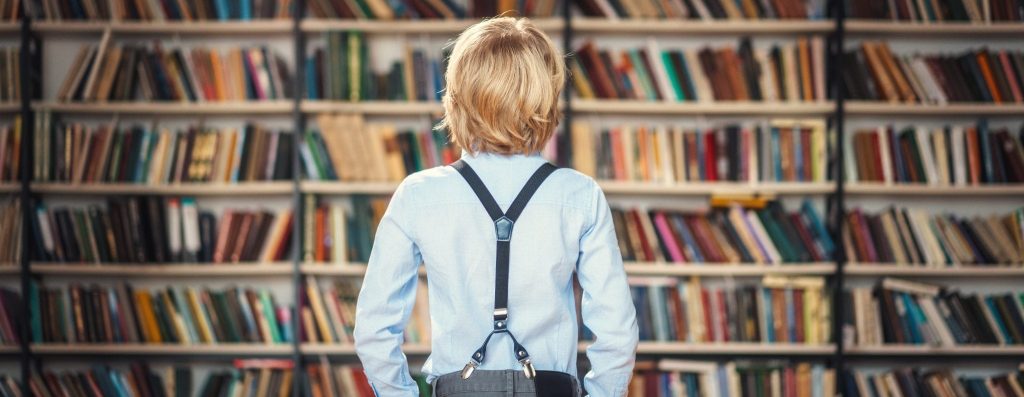 boy looking at library books